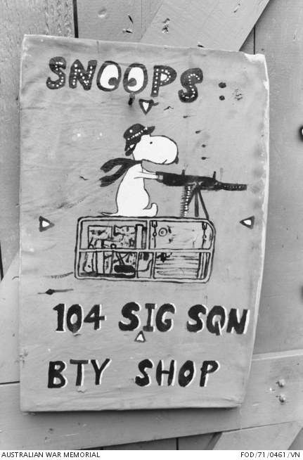Black and white 1971 photograph of a hand-painted Snoopy on a sign at a Royal Australian Artillery battery shop in Vietnam