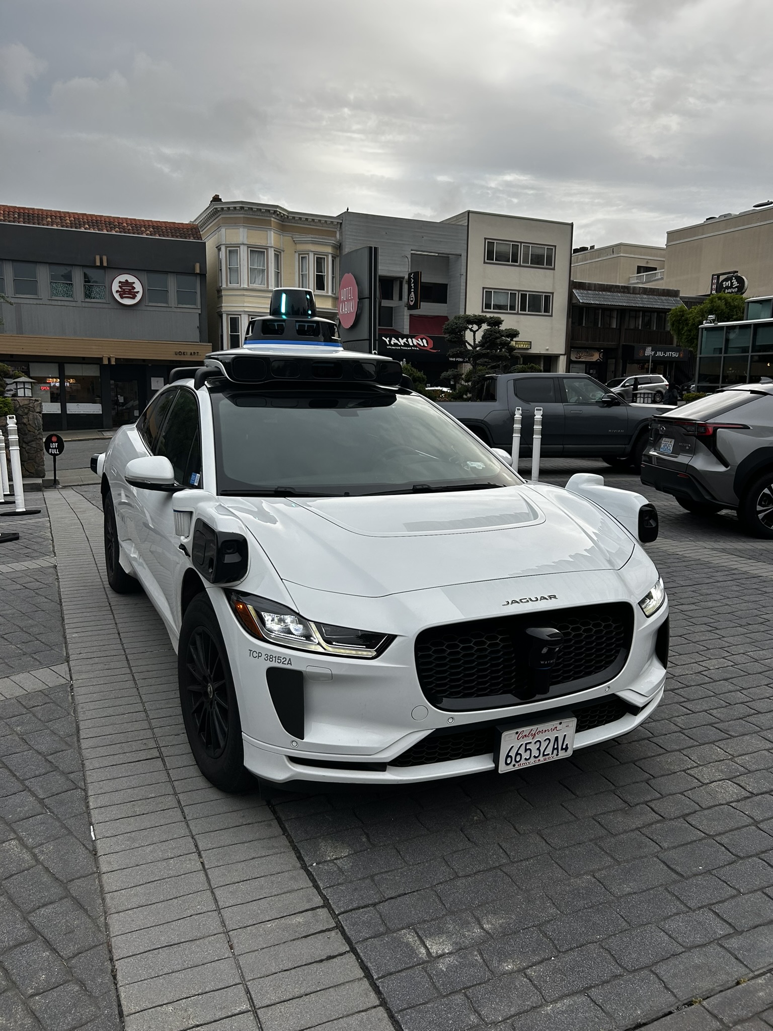 The Waymo Jaguar I-PACE from the front — sensor dome and Jaguar badge visible